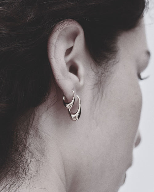 silver earrings on ear