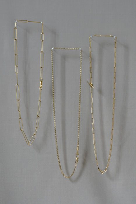 Three gold chains hanging 