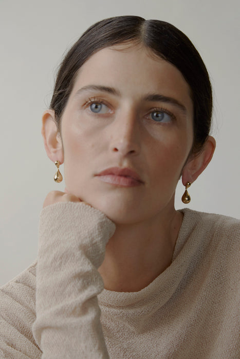 model wears gold earrings 