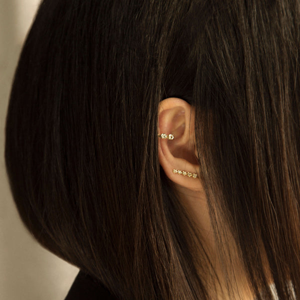 An image of Alex Eagle wearing her ear pin and cuff which was designed in collaboration with Otiumberg and now for sale online.